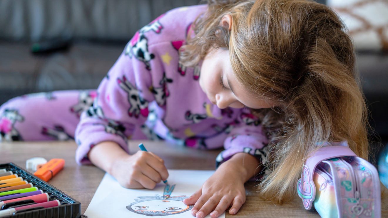 Child drawing on a coffee table